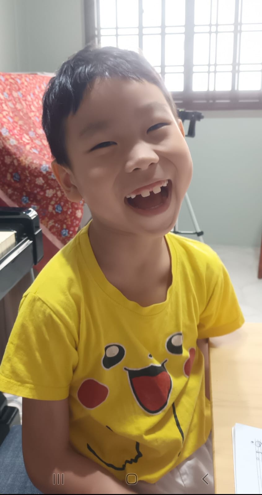 An introductory piano trial session showing a student happily playing their first few notes.